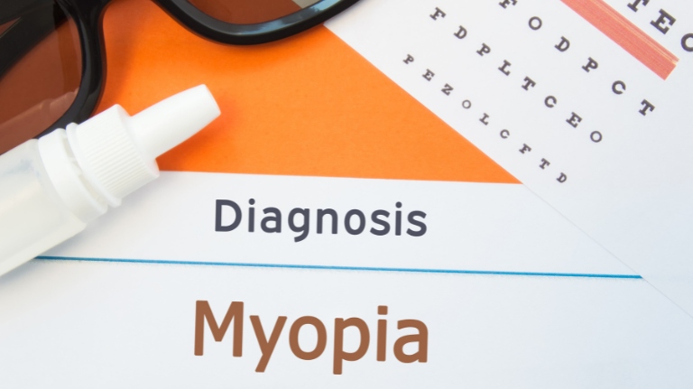 Myopia diagnosis shown with eyeglasses, eye drops, and an eye chart used during an eye exam